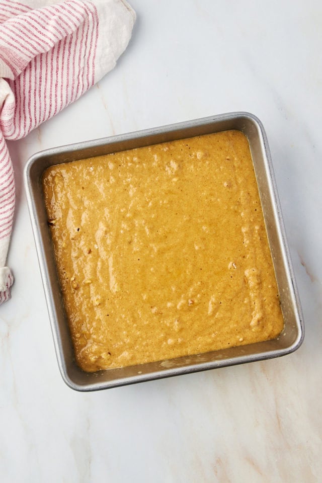 overhead view of applesauce cake batter in a square baking pan