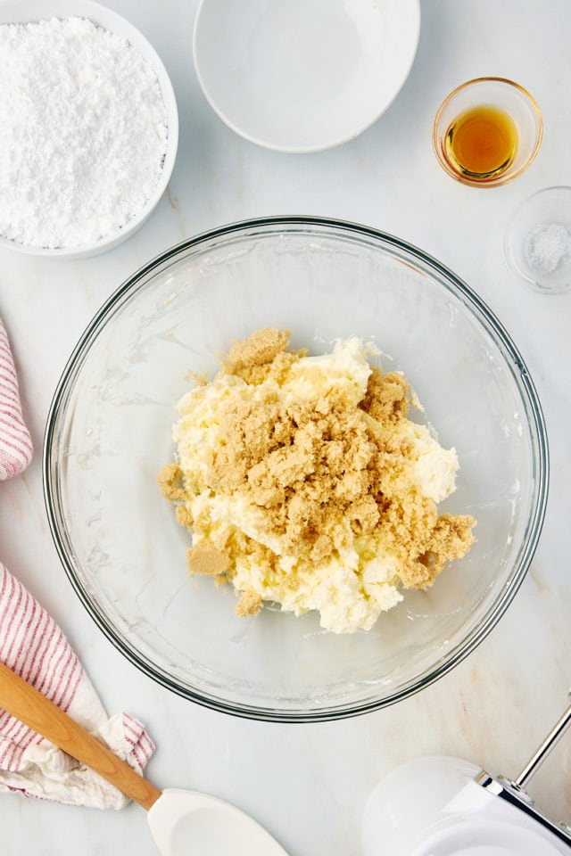 overhead view of brown sugar added to creamed butter and cream cheese