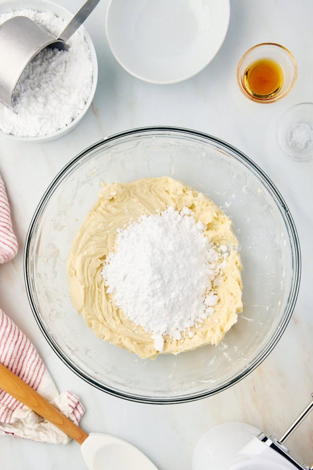 overhead view of confectioners' sugar added to brown sugar frosting