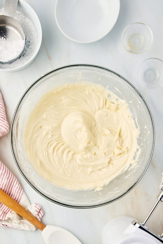 overhead view of brown sugar cream cheese frosting in a glass mixing bowl