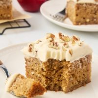 slice of applesauce cake on a plate with a bite on a fork