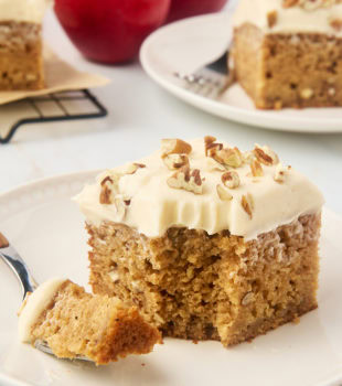 slice of applesauce cake on a plate with a bite on a fork