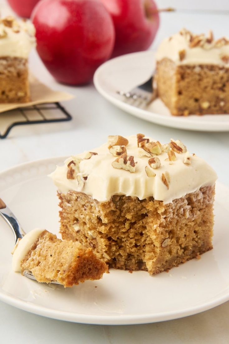 slice of applesauce cake on a plate with a bite on a fork