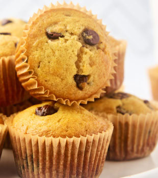 chocolate chip muffins piled on a white plate