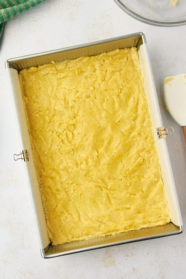 overhead view of gooey butter cake crust spread in a 9x13 pan