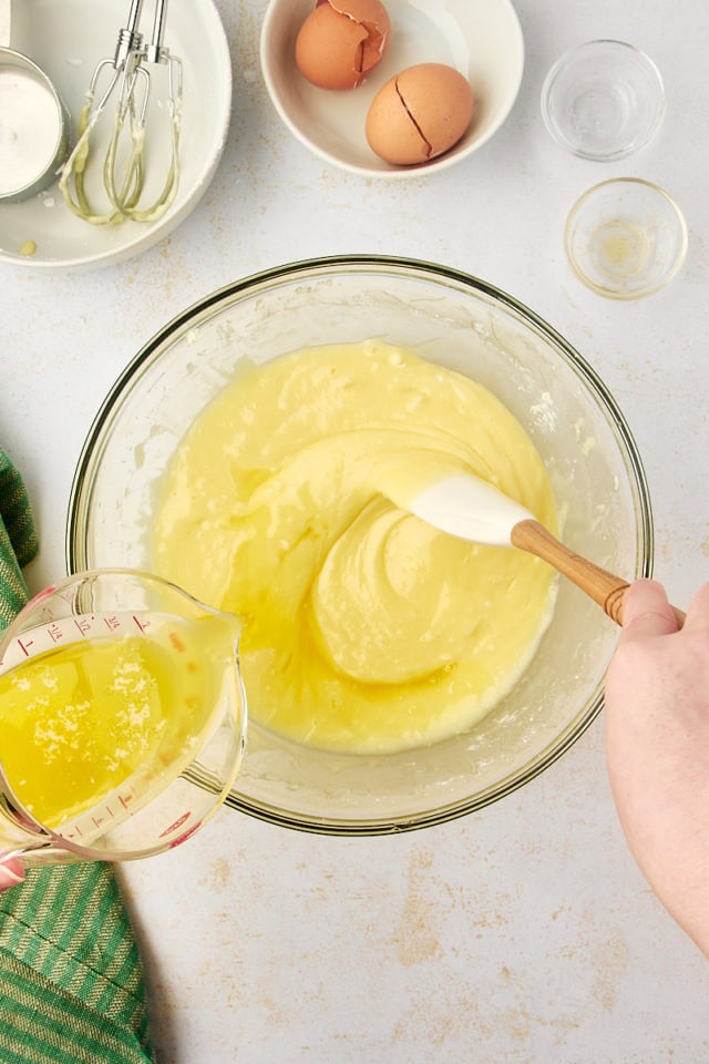 overhead view of melted butter being added slowly to filling mixture for gooey butter cake