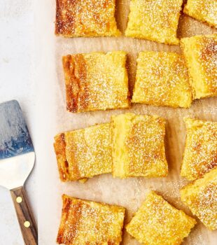 overhead view of gooey butter cake slices on parchment paper