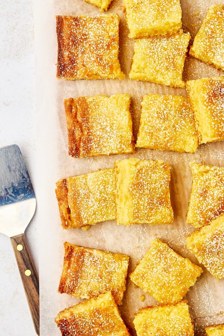 overhead view of gooey butter cake slices on parchment paper