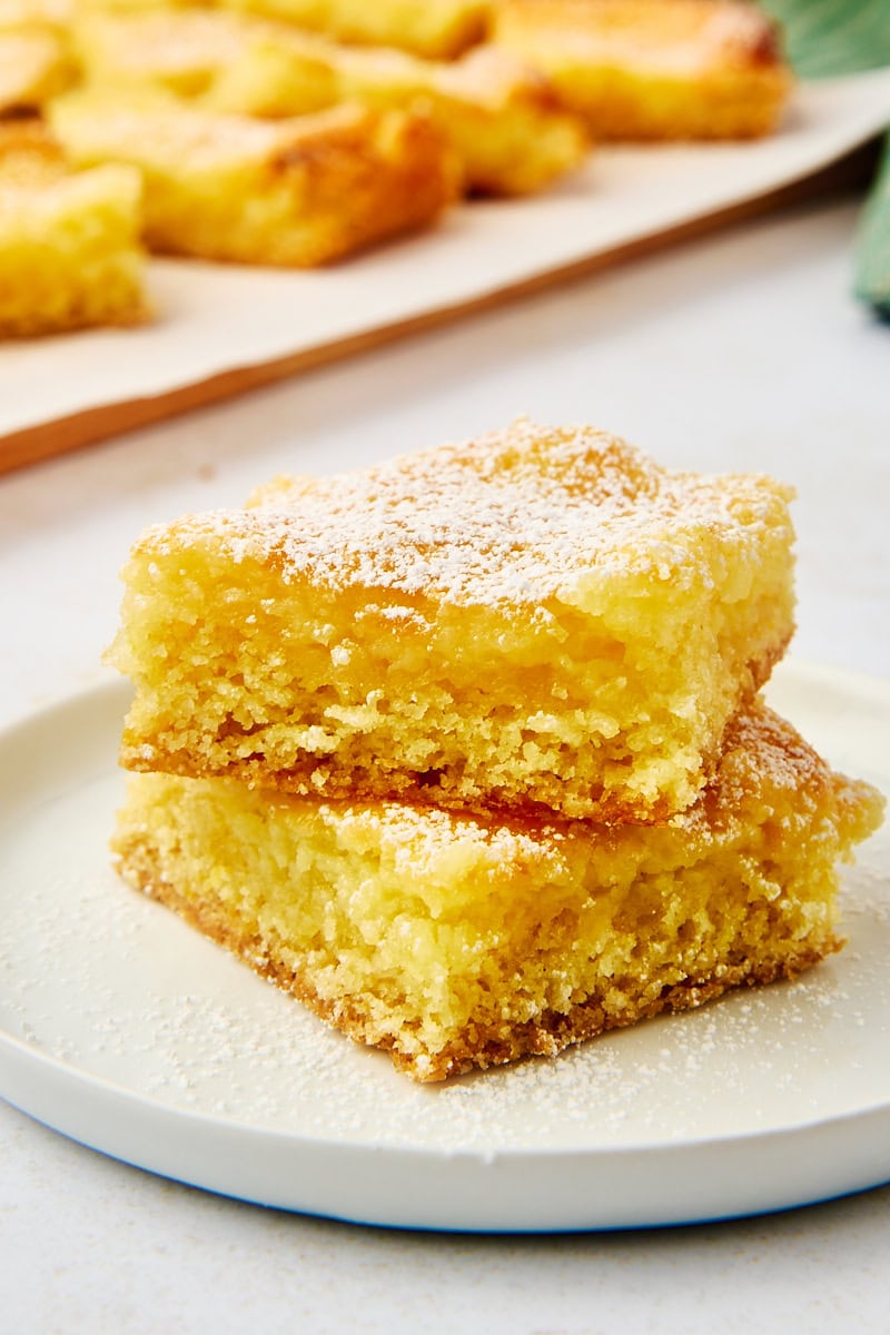 stack of two pieces of gooey butter cake on a white plate