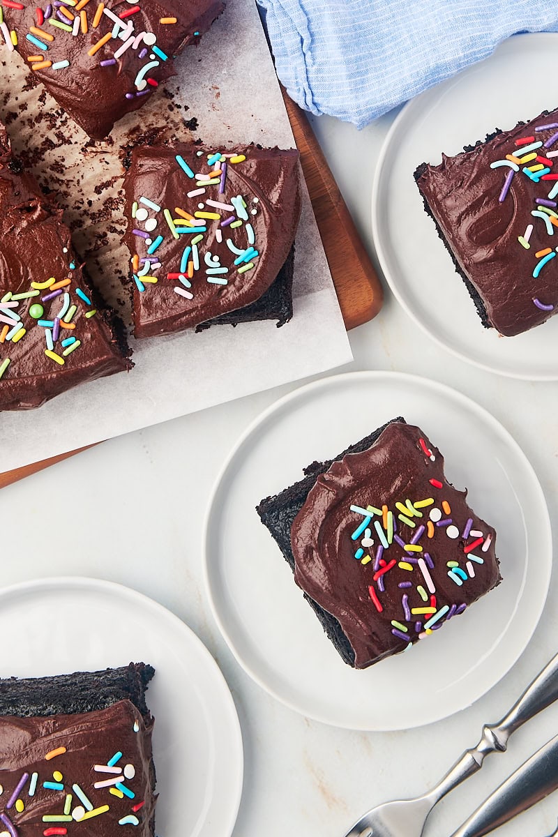 overhead view of slices of one-bowl chocolate cake on white plates