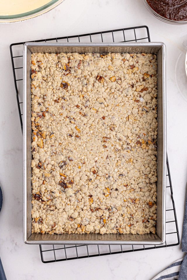 overhead view of partially baked oat crust for apple butter cream cheese oat bars