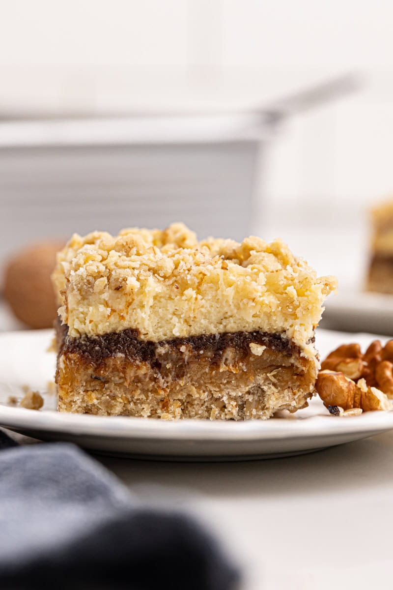 an apple butter cream cheese oat bar on a white plate