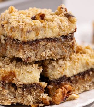 three apple butter cream cheese oat bars on a white plate