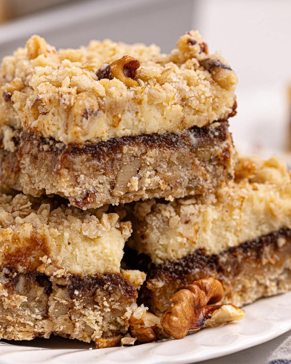 three apple butter cream cheese oat bars on a white plate