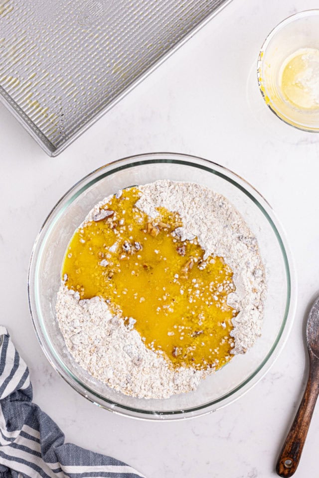 overhead view of melted butter added to oat crust mixture