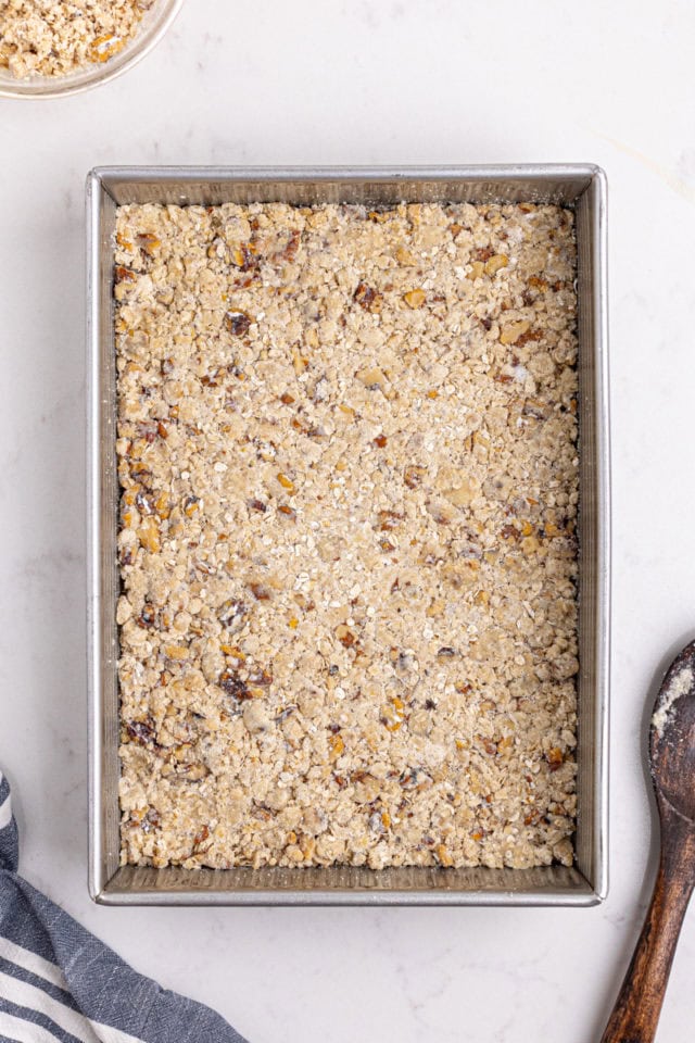 overhead view of oat crust mixture pressed into a 9x13 pan