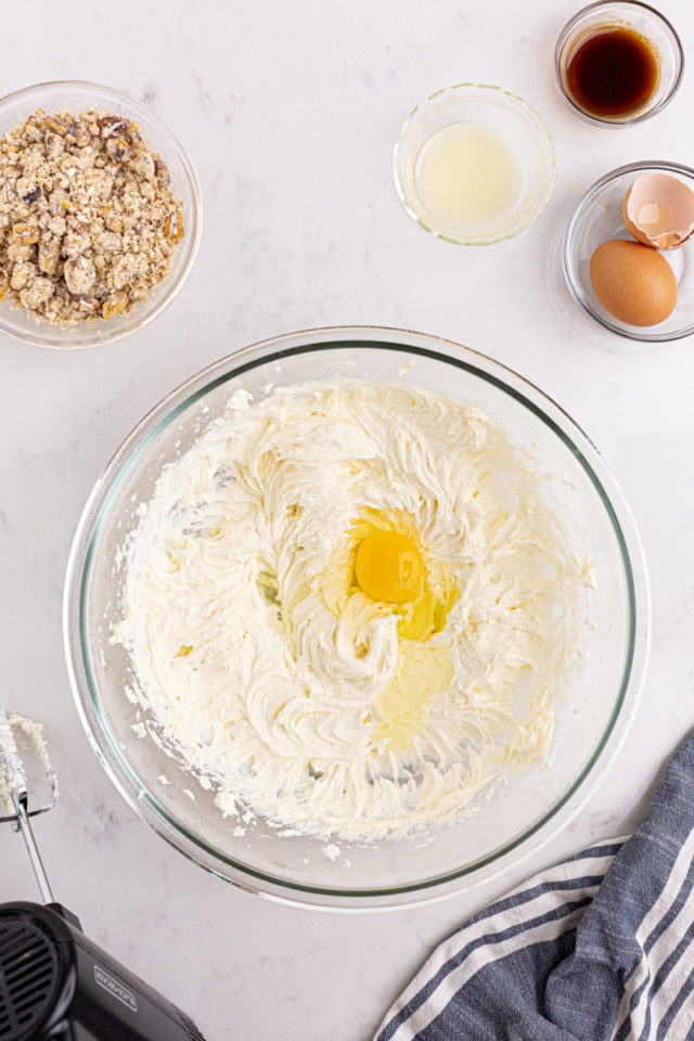 overhead view of egg added to cheesecake mixture