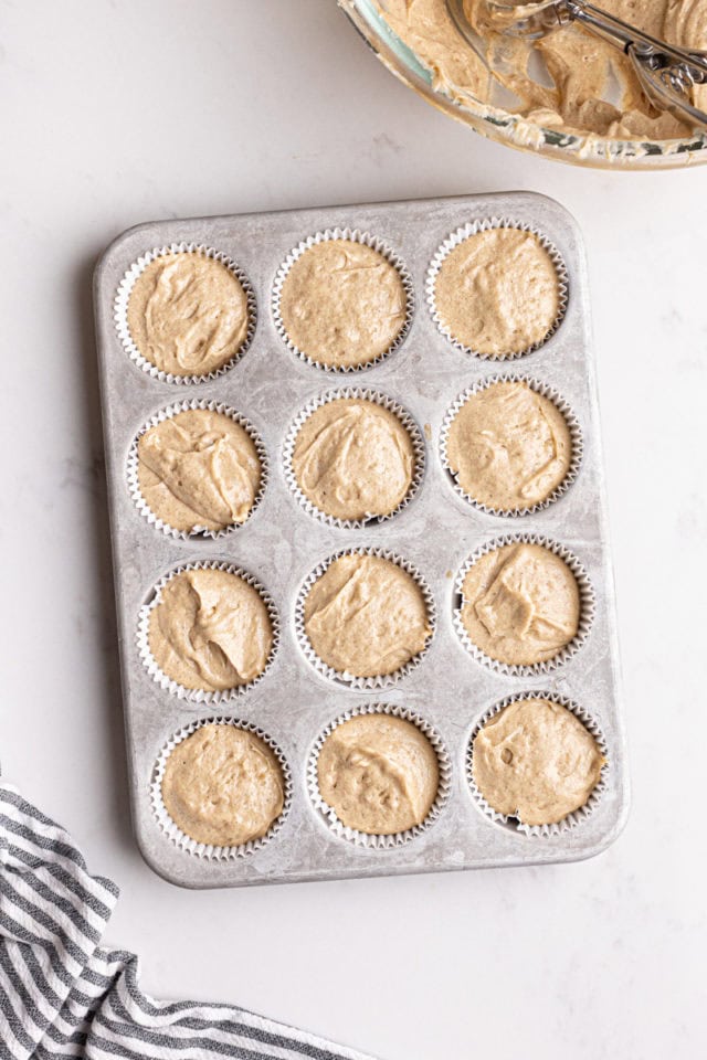 overhead view of chai spice cupcake batter in a muffin pan ready to go into the oven