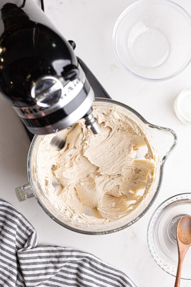 overhead view of mixed chai spice frosting in the bowl of a stand mixer