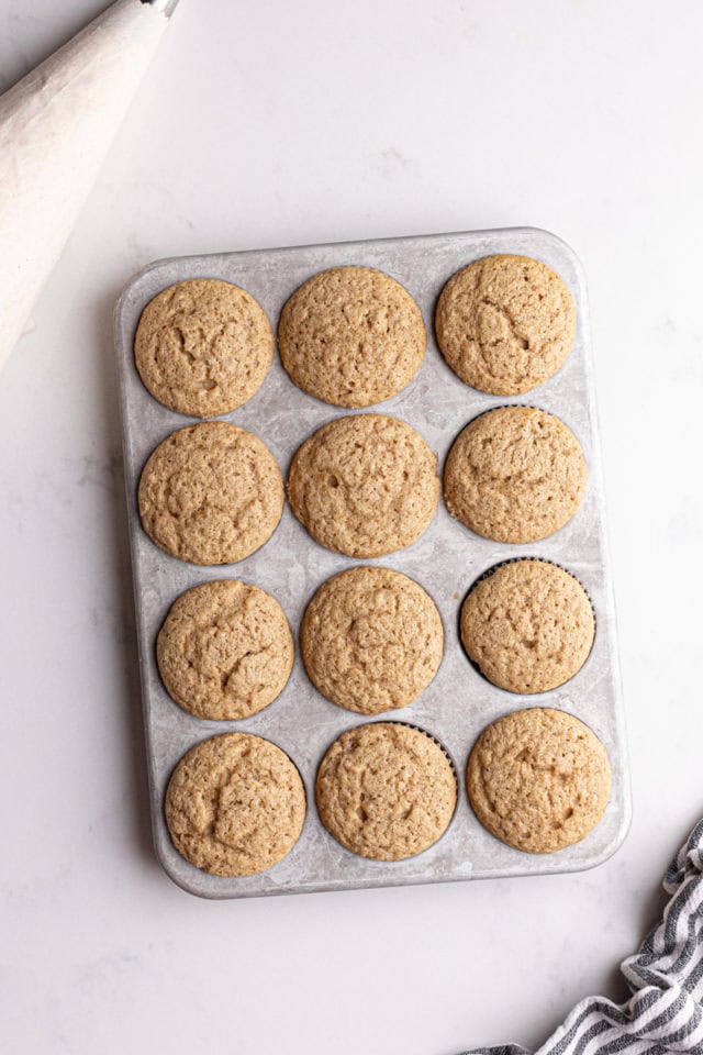 overhead view of freshly baked chai spice cupcakes in a muffin pan