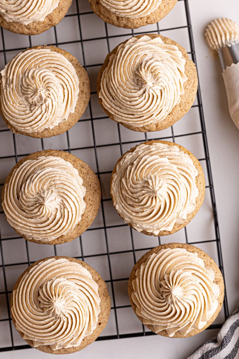 overhead view of frosted chai spice cupcakes on a wire rack