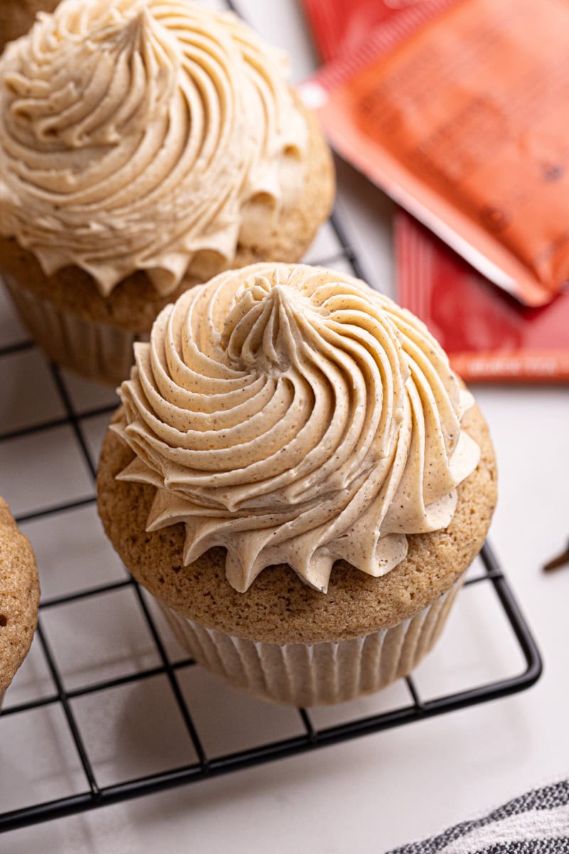 two chai spice cupcakes on a wire rack