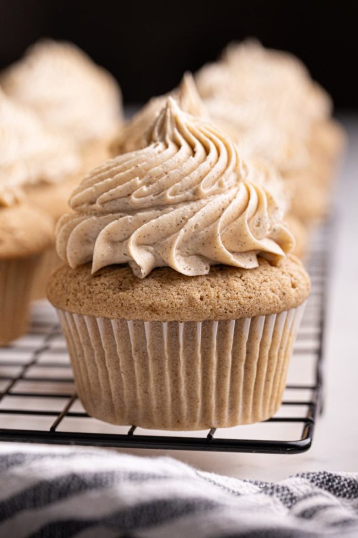 chai spice cupcakes lined up on a wire rack