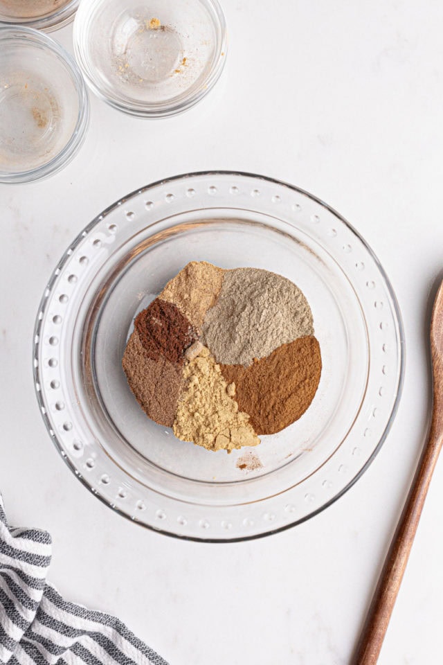 overhead view of chai spices in a glass bowl