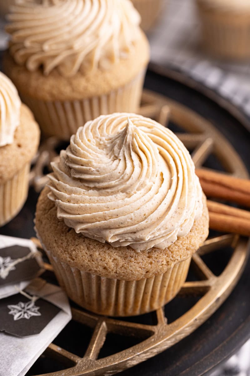 a chai spice cupcake on a brass and black cake stand