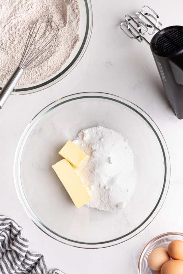 overhead view of sugar and butter in a glass mixing bowl