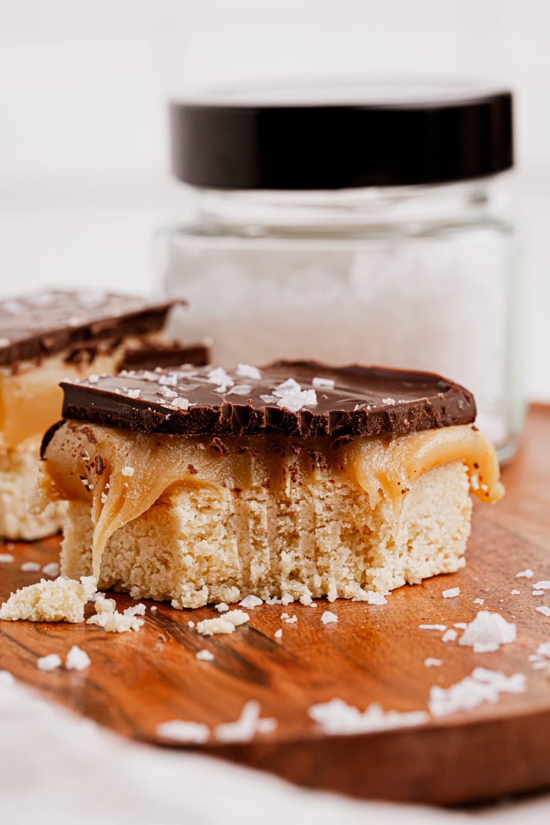 a millionaire shortbread bar with a bite missing