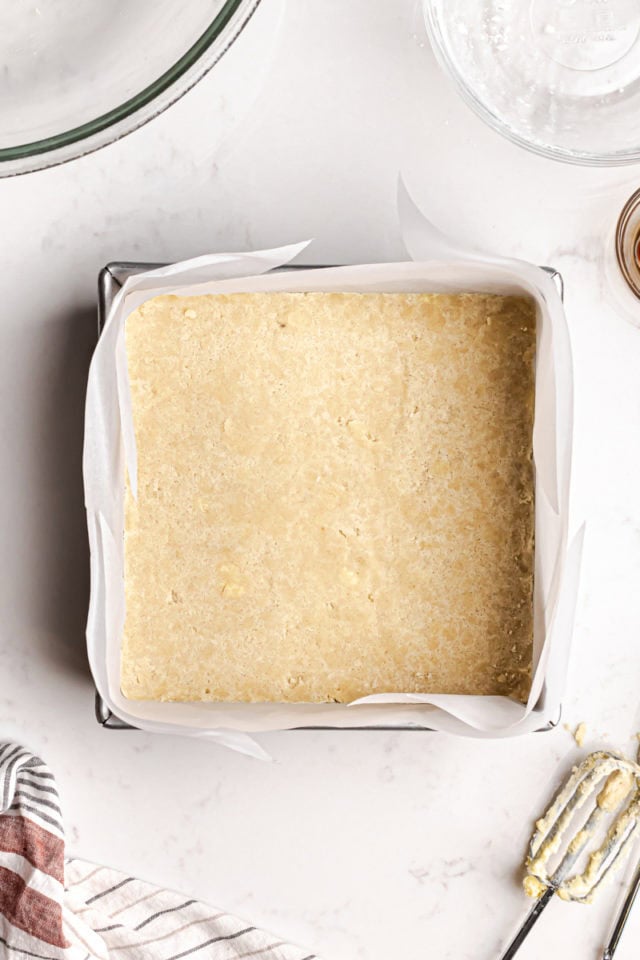 overhead view of shortbread pressed into a lined baking pan