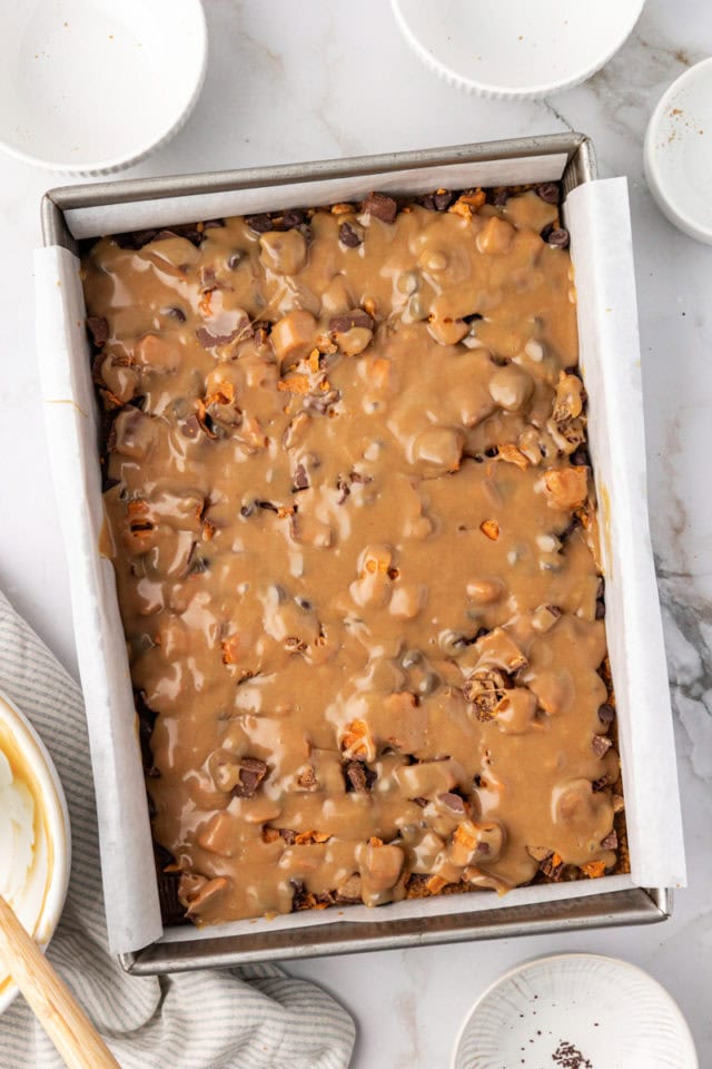 overhead view of assembled peanut butter candy bar squares ready to go into the oven