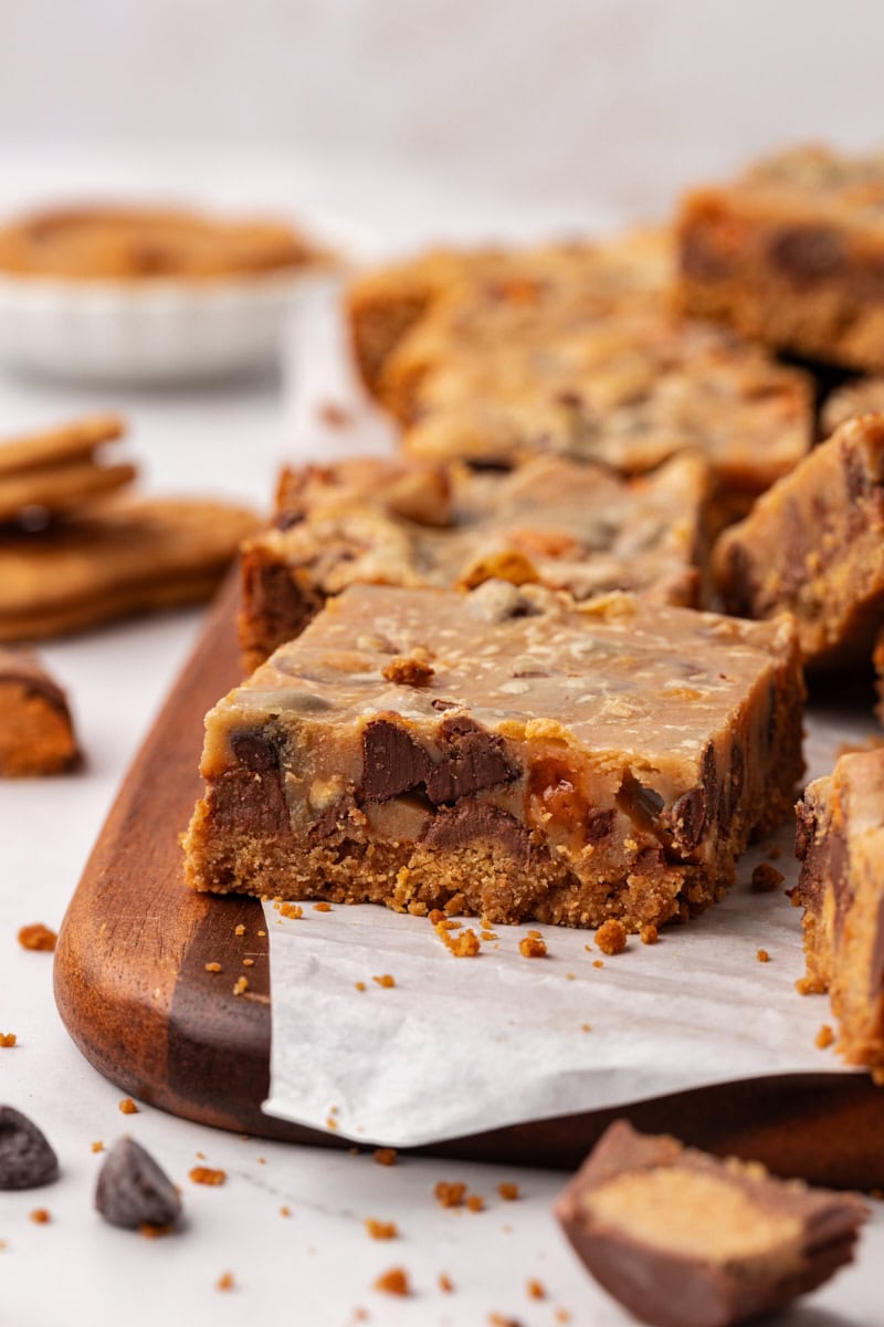 peanut butter candy bar squares on a wooden board