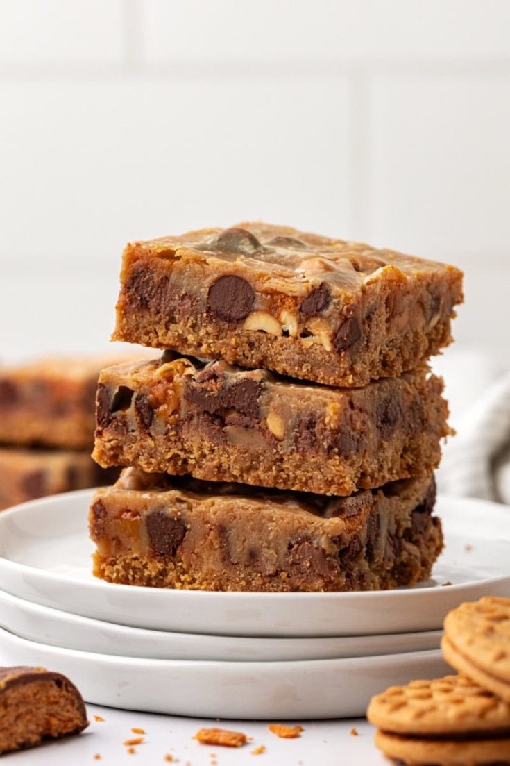 stack of three peanut butter candy bar squares on a white plate