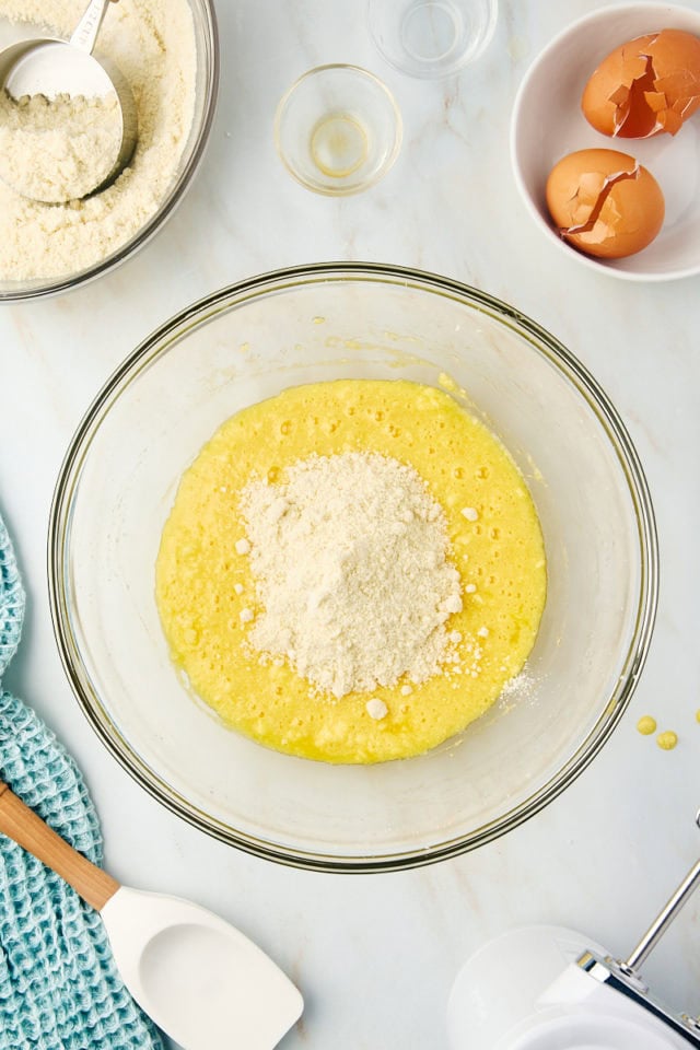 overhead view of dry ingredients added to wet ingredients for almond torte