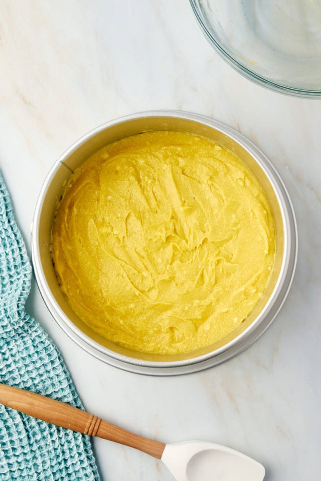 overhead view of almond torte batter spread in a springform pan