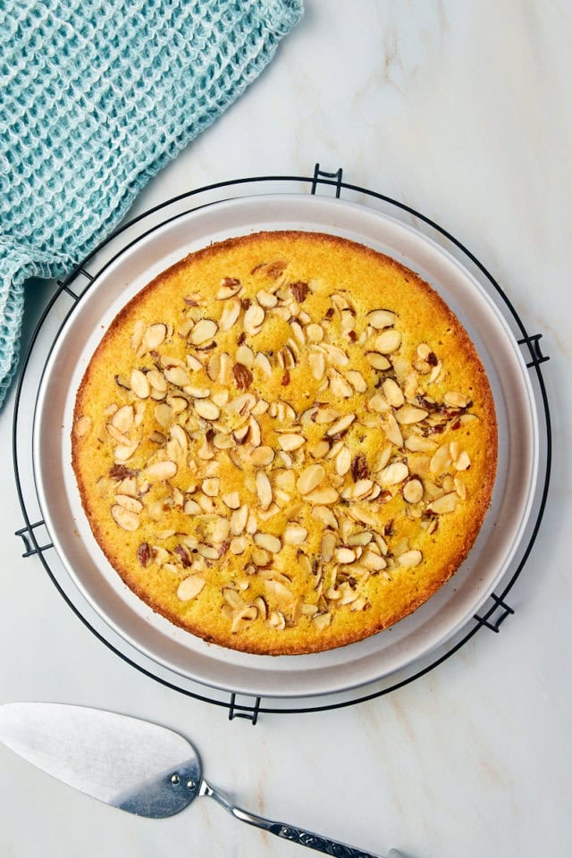 overhead view of freshly baked almond torte on a wire rack