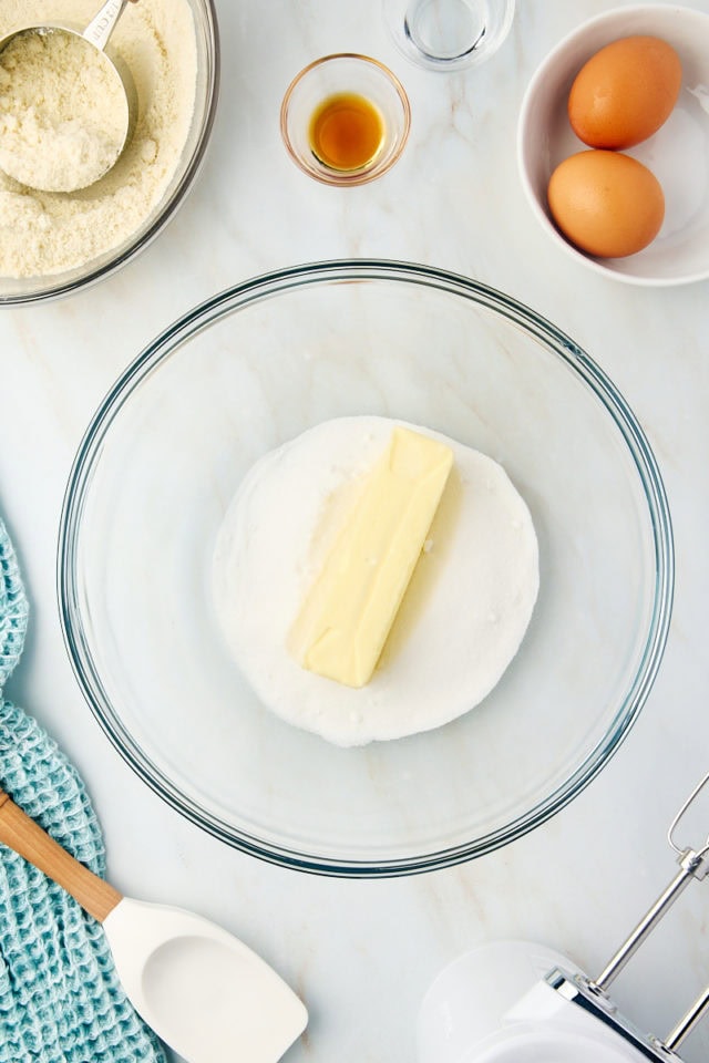 overhead view of butter and sugar in a glass mixing bowl