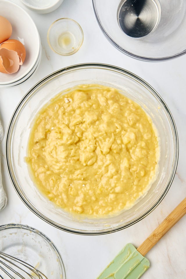 overhead view of mixed banana bread batter in a glass mixing bowl