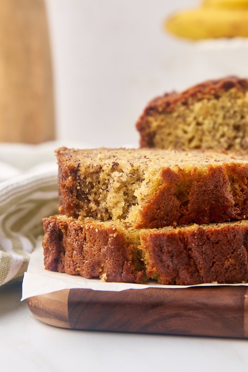 stack of two slices of banana bread with a bite missing from the top slice