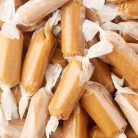 close-up of homemade soft caramels wrapped in wax paper