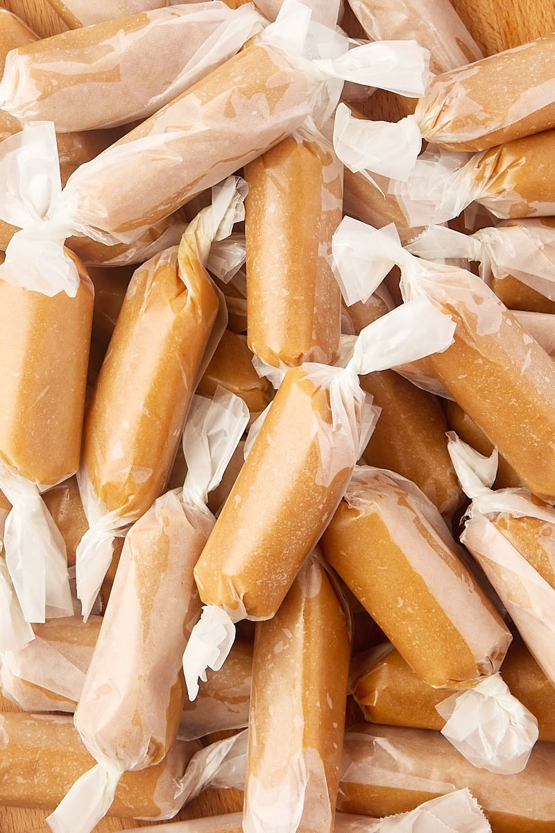 close-up of homemade soft caramels wrapped in wax paper