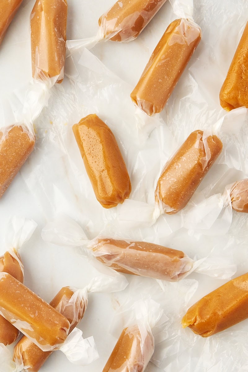 several homemade soft caramels on parchment paper