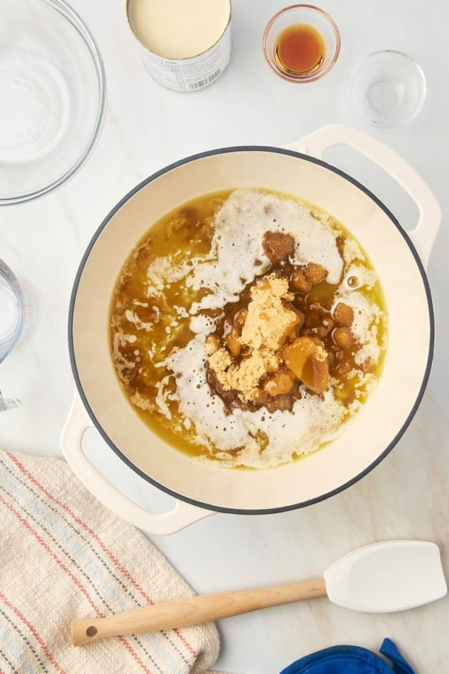 overhead view of brown sugar, corn syrup, and salt added to melted butter in a large saucepan