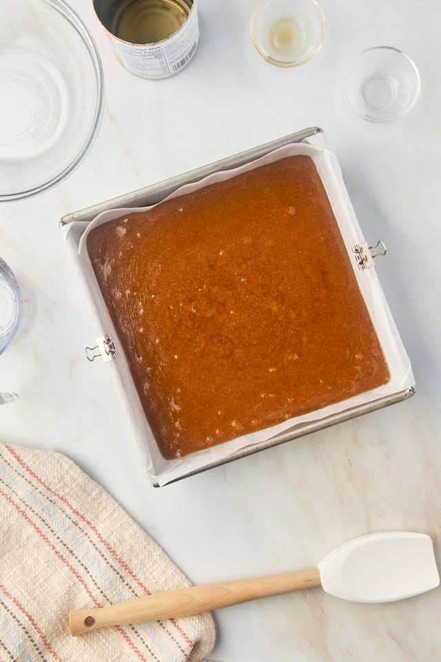 overhead view of caramel mixture in a parchment-lined pan