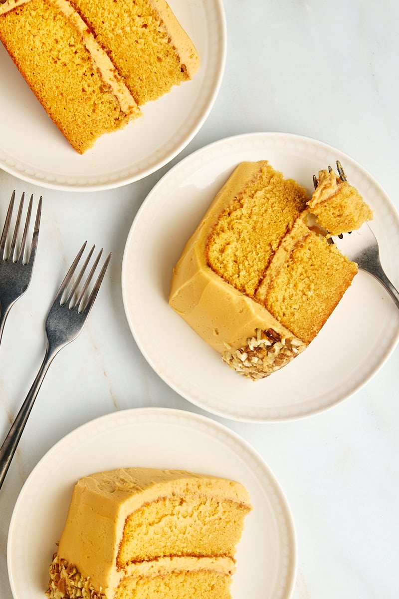 overhead view of three slices of dulce de leche cake on plates