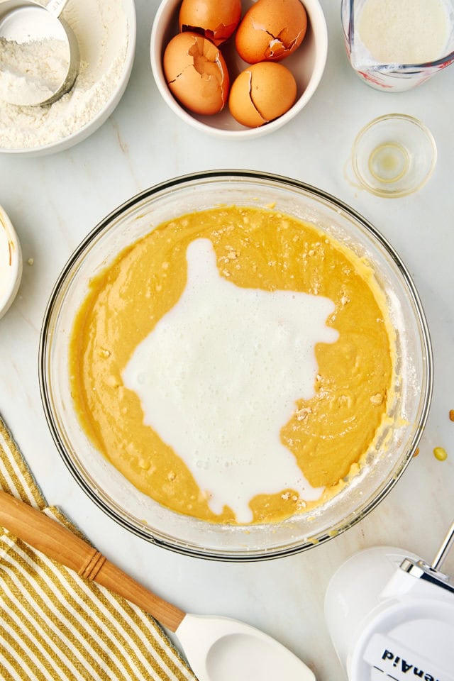 overhead view of buttermilk added to dulce de leche cake batter