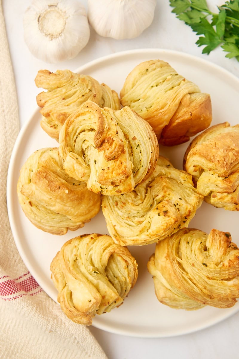 overhead view of garlic butter cruffins on a large white plate