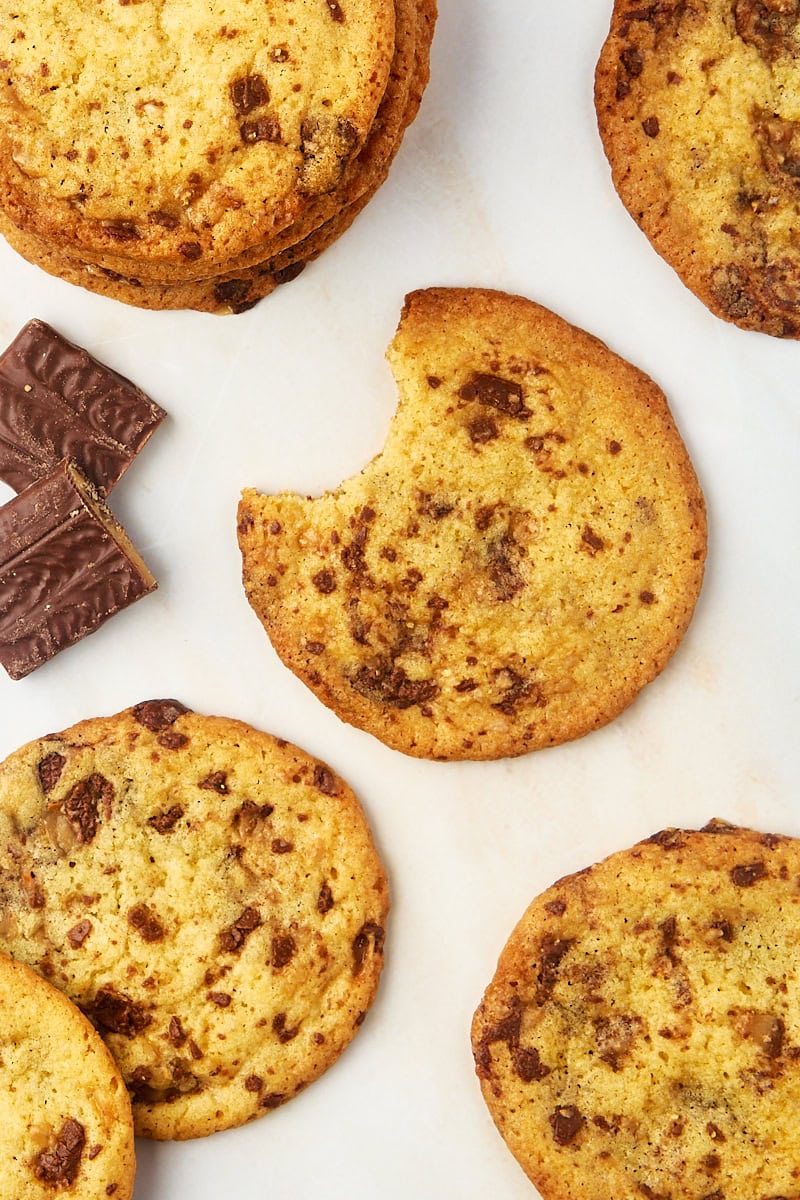 Overhead view of Heath bar cookies on countertop with bite taken out of one